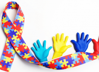 Autism ribbon with puzzle pieces and hands