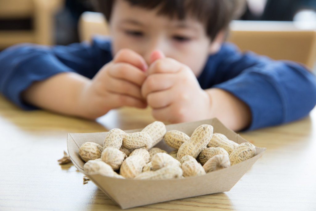child holding peanuts, food allergies, peanut allergy