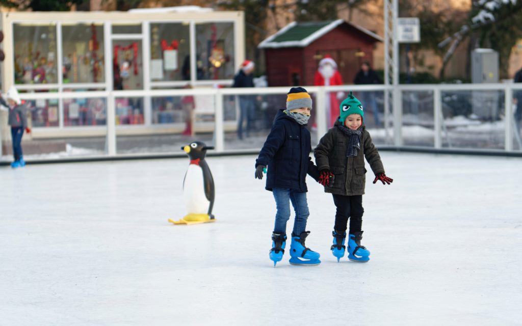 two kids ice skating | start getting out the door faster with these 6 tips