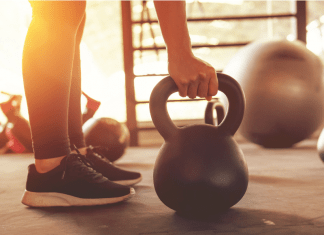 gym-timidation; woman holding kettle bell