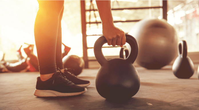 gym-timidation; woman holding kettle bell