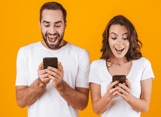 iphone visual lookup; man and woman looking at phones